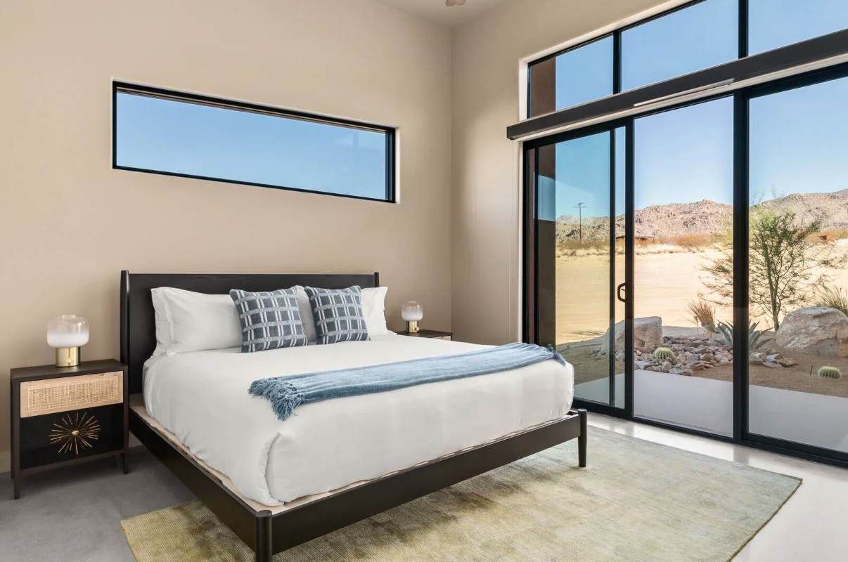 Guest bedroom with sliding glass doors onto the desert