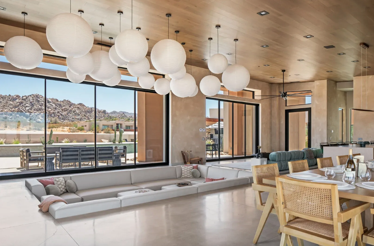 Sunken living room with paper lantern pendants and floor-to-ceiling glass